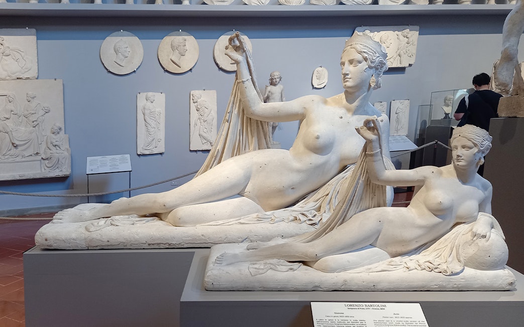 Sculptures in Accademia Gallery, Florence, Italy, with classical figures in reclining poses.