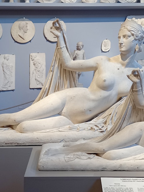 Sculptures in Accademia Gallery, Florence, Italy, with classical figures in reclining poses.