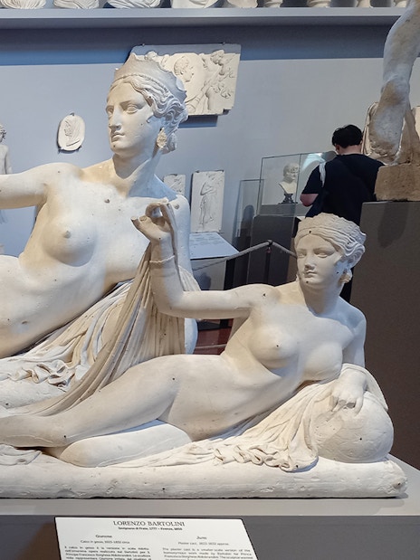 Sculptures in Accademia Gallery, Florence, Italy, with classical figures in reclining poses.