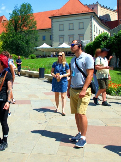 Tour group exploring Wawel Castle grounds in Krakow.