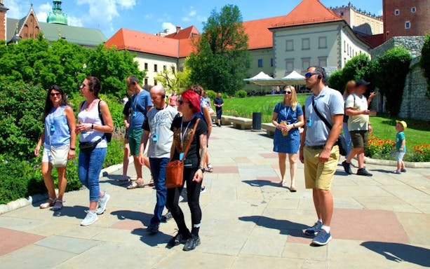 Tour group exploring Wawel Castle grounds in Krakow.