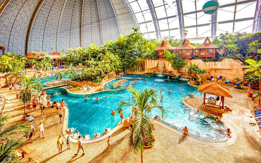 Indoor water park with pools and tropical plants at Tropical Islands Resort.