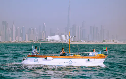 Boat tour with Dubai skyline in background, part of Jumeirah Swimming Tour.