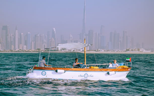 Boat tour with Dubai skyline in background, part of Jumeirah Swimming Tour.