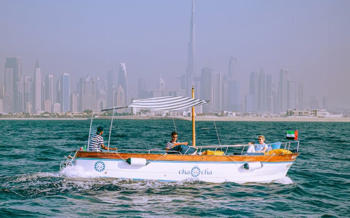 Boat tour with Dubai skyline in background, part of Jumeirah Swimming Tour.