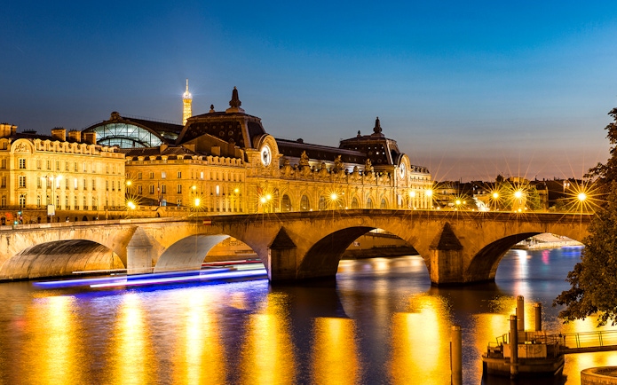 Musée d'Orsay and Eiffel Tower illuminated at night, Paris.