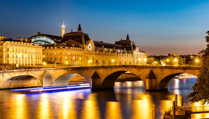 Musee'de Orsay illuminated at night with yellow lights