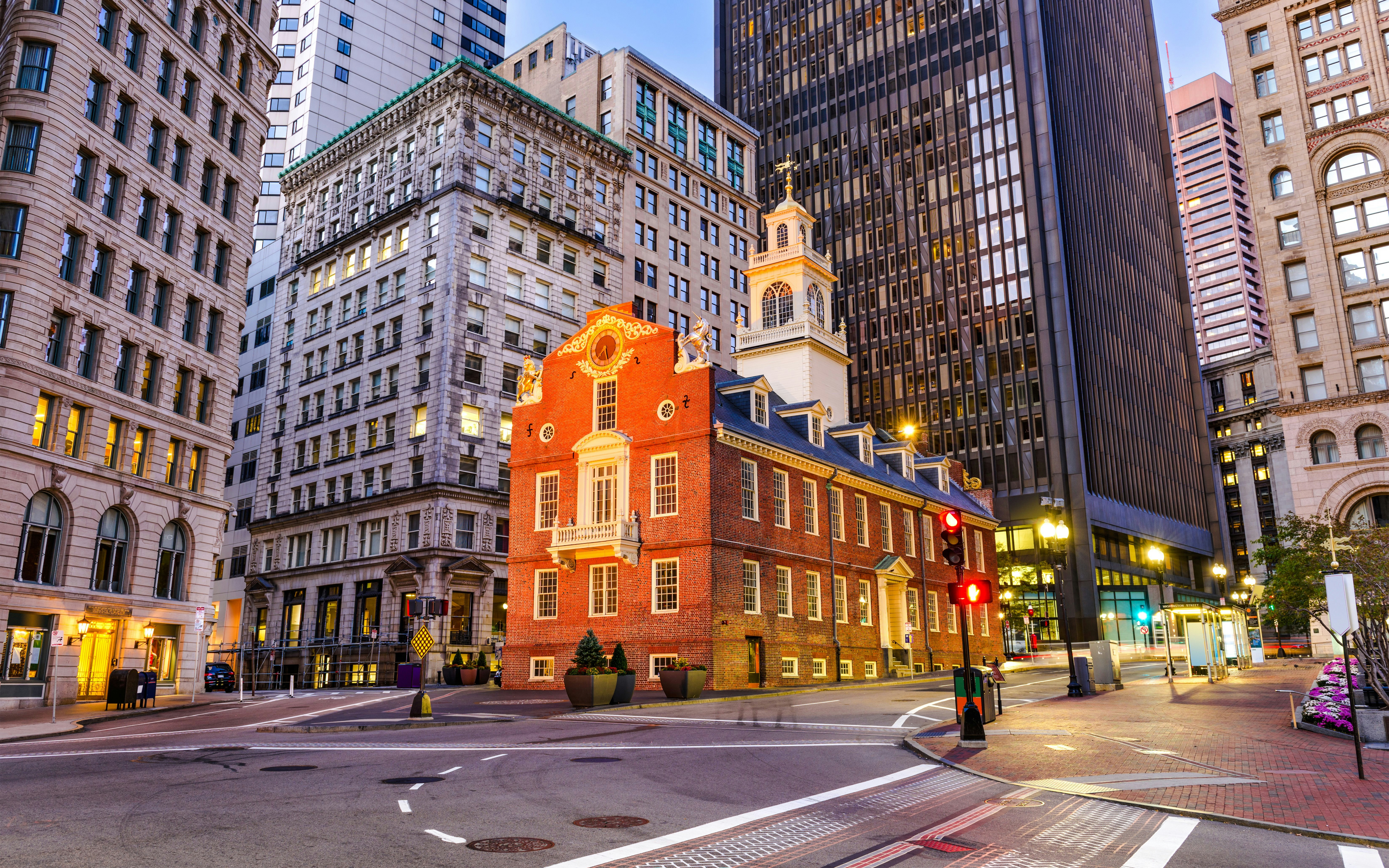 Old State House in Boston surrounded by modern buildings at dusk.