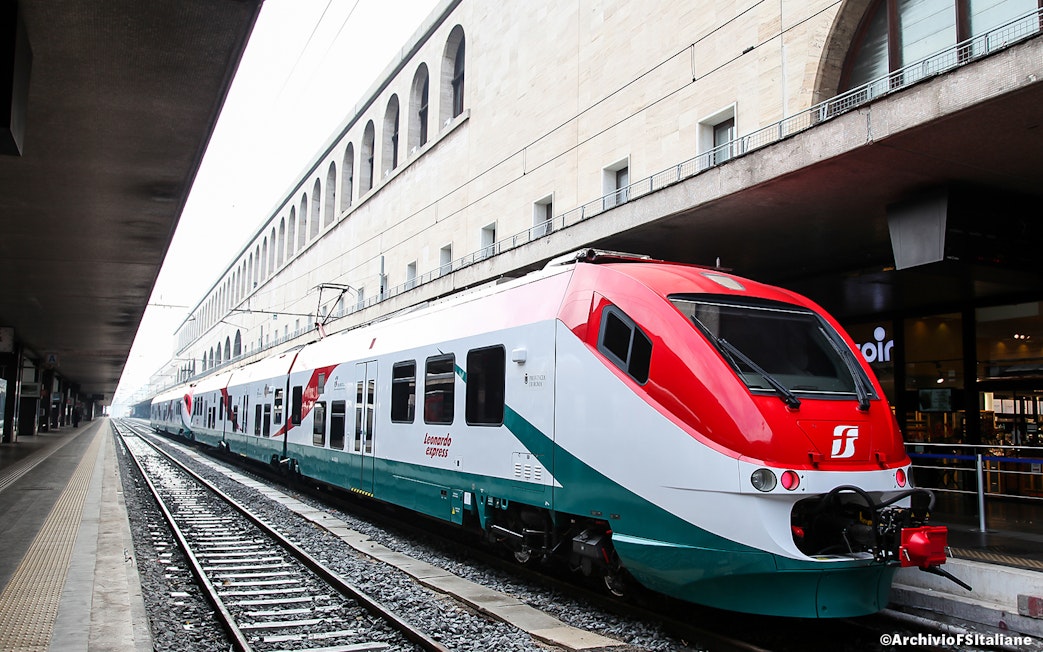 Leonardo Express train at Rome Termini Station platform, connecting to Fiumicino Airport.