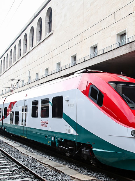 Leonardo Express train at Rome Termini Station platform, connecting to Fiumicino Airport.
