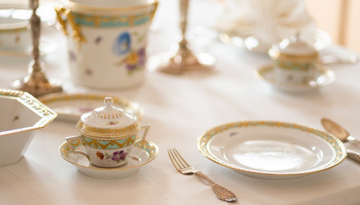 expensive retro royal majesty porcelain service plates and cutlery in a palace