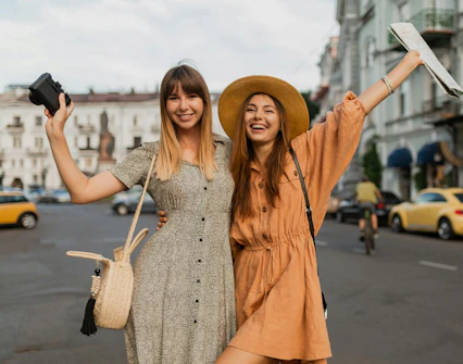 Two women enjoying a self-guided city exploration game in Vienna, holding a map and camera.
