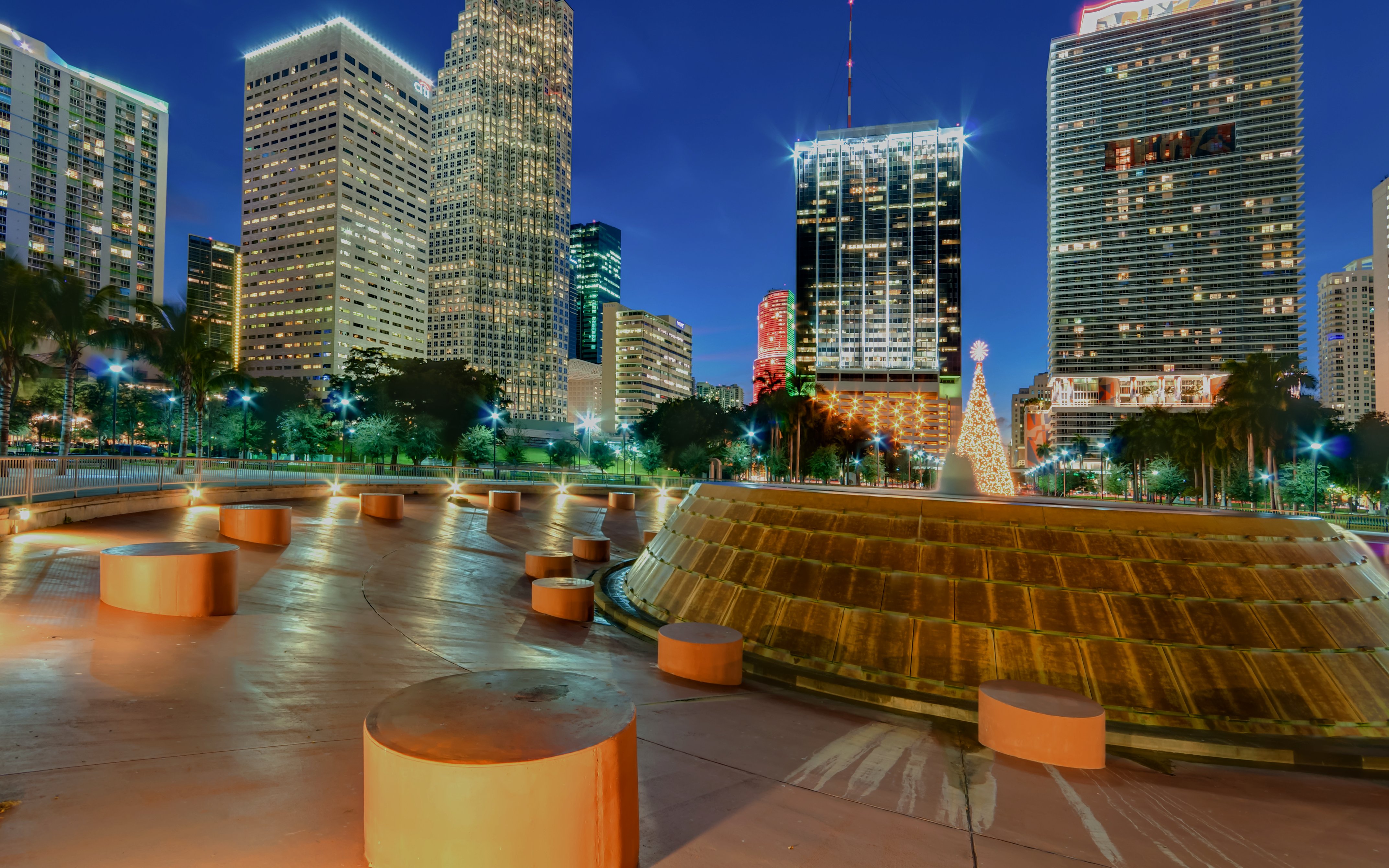 Miami Bayfront Park at night with Christmas lights and city skyline.