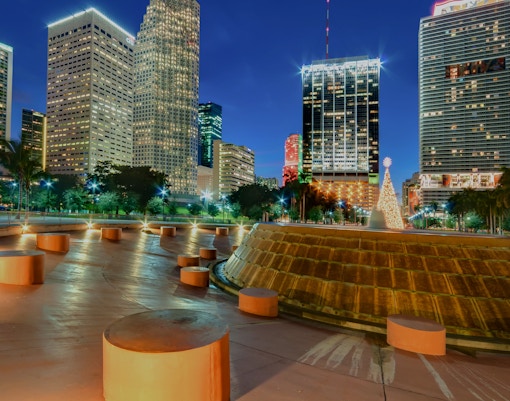 Miami Bayfront Park at night with Christmas lights and city skyline.