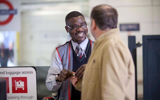 Customer interacting with staff while boarding Stansted Express.