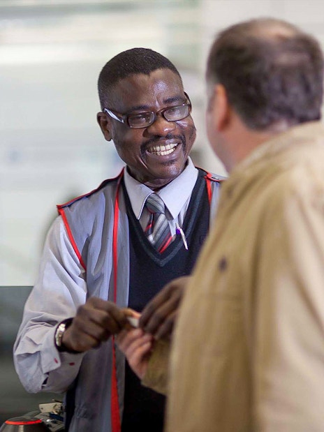 Customer interacting with staff while boarding Stansted Express.