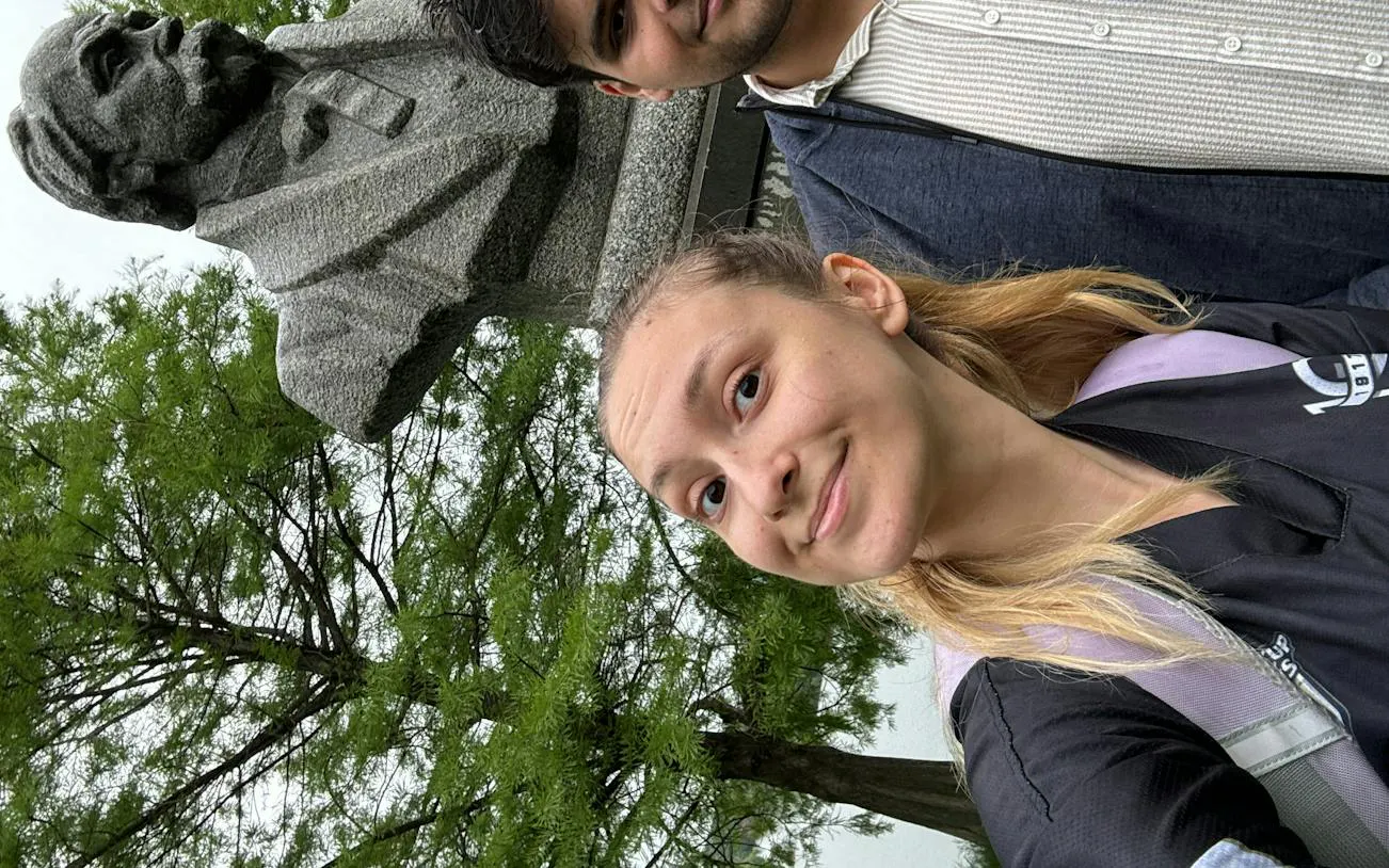 Selfie with a statue in a Bucharest park, part of the Romantic Bucharest self-guided city exploration game.