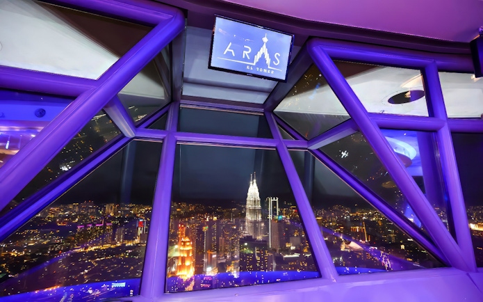 View of Kuala Lumpur cityscape from ARAS restaurant in KL Tower at night.