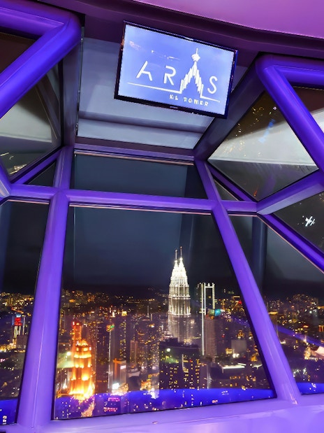 View of Kuala Lumpur cityscape from ARAS restaurant in KL Tower at night.