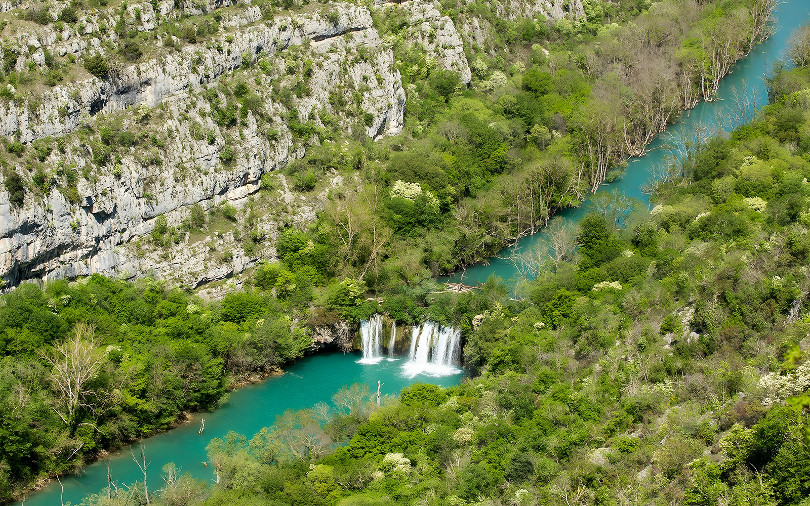 Rošnjak waterfall flowing through lush greenery at Krka National Park, Croatia.