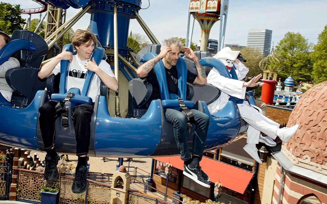 Visitors enjoying a ride at Tivoli Gardens amusement park in Copenhagen.
