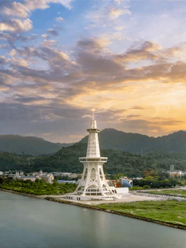 Maha Tower at sunset with surrounding landscape and water.
