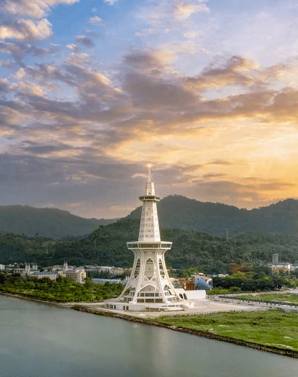 Maha Tower at sunset with surrounding landscape and water.