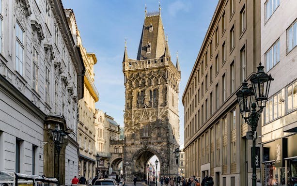Powder Tower in Prague with surrounding street and buildings.