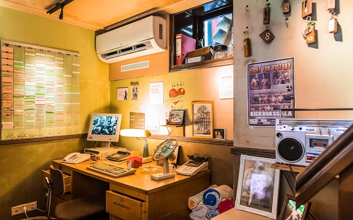 Office setup with vintage computer and decor at Red Light Secrets Museum of Prostitution.