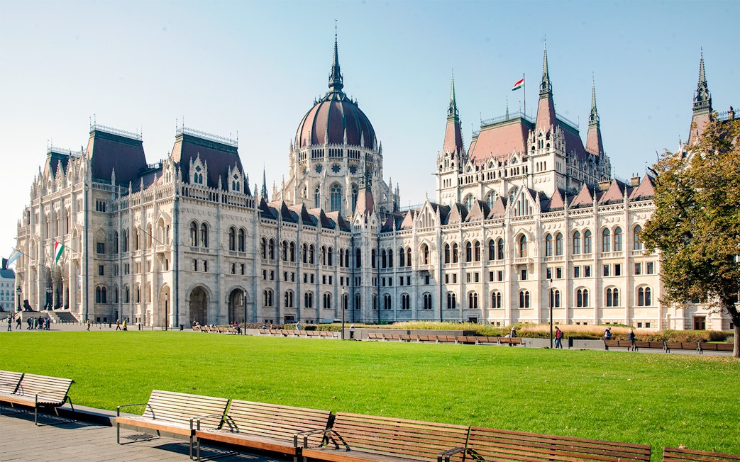 Hungarian Parliament building with green lawn, part of Grand City Tour.
