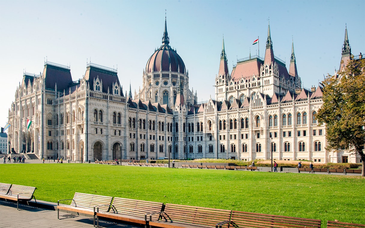 Hungarian Parliament building with green lawn, part of Grand City Tour.