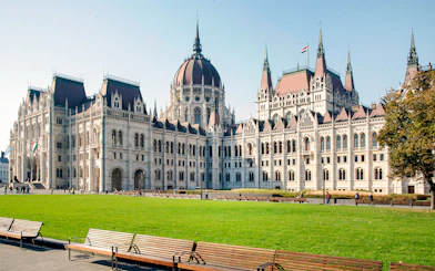 Hungarian Parliament building with green lawn, part of Grand City Tour.
