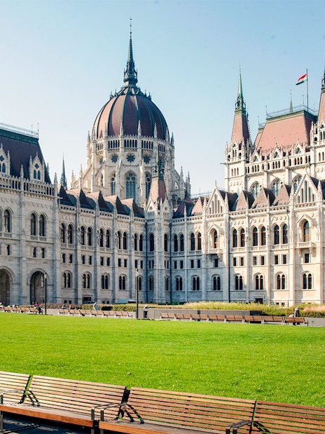 Hungarian Parliament building with green lawn, part of Grand City Tour.