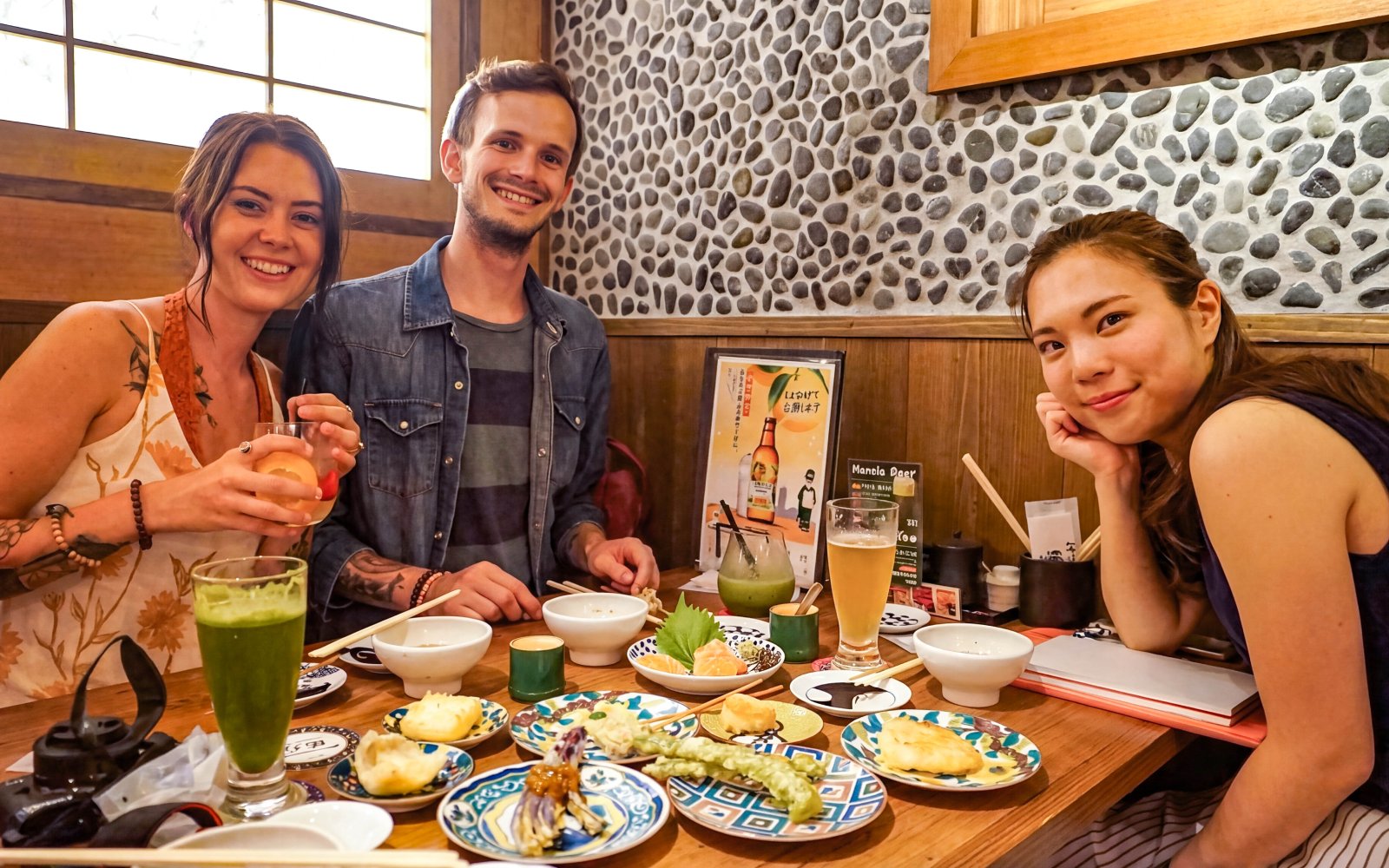 Group enjoying traditional Japanese dishes on Kyoto Night Foodie Tour.