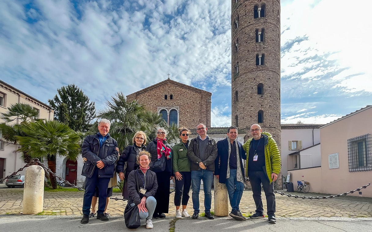 Group of tourists in front of Basilica of Sant'Apollinare Nuovo, Ravenna, UNESCO tour.