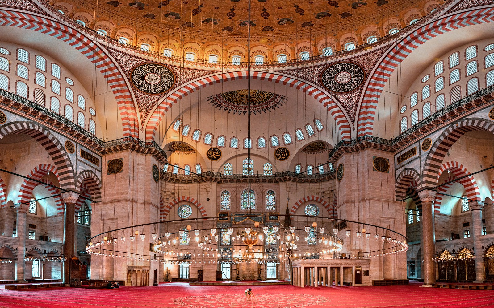 Suleymaniye Mosque interior with ornate domes and arches, Istanbul tour.