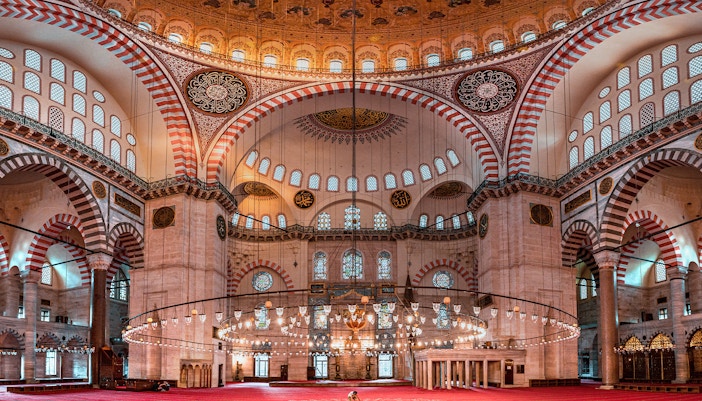 Suleymaniye Mosque interior with ornate domes and arches, Istanbul tour.