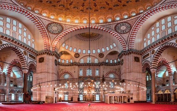 Suleymaniye Mosque interior with ornate domes and arches, Istanbul tour.