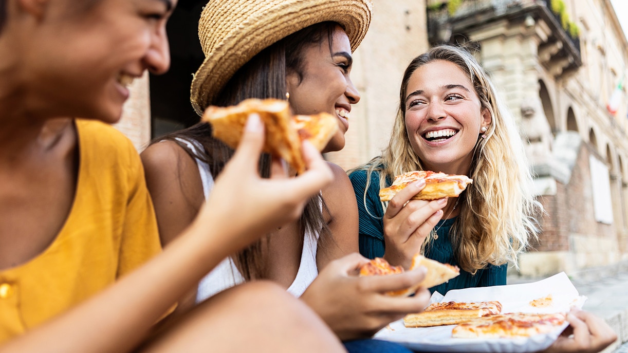 Women enjoying street food at Tivoli Town, Italy.