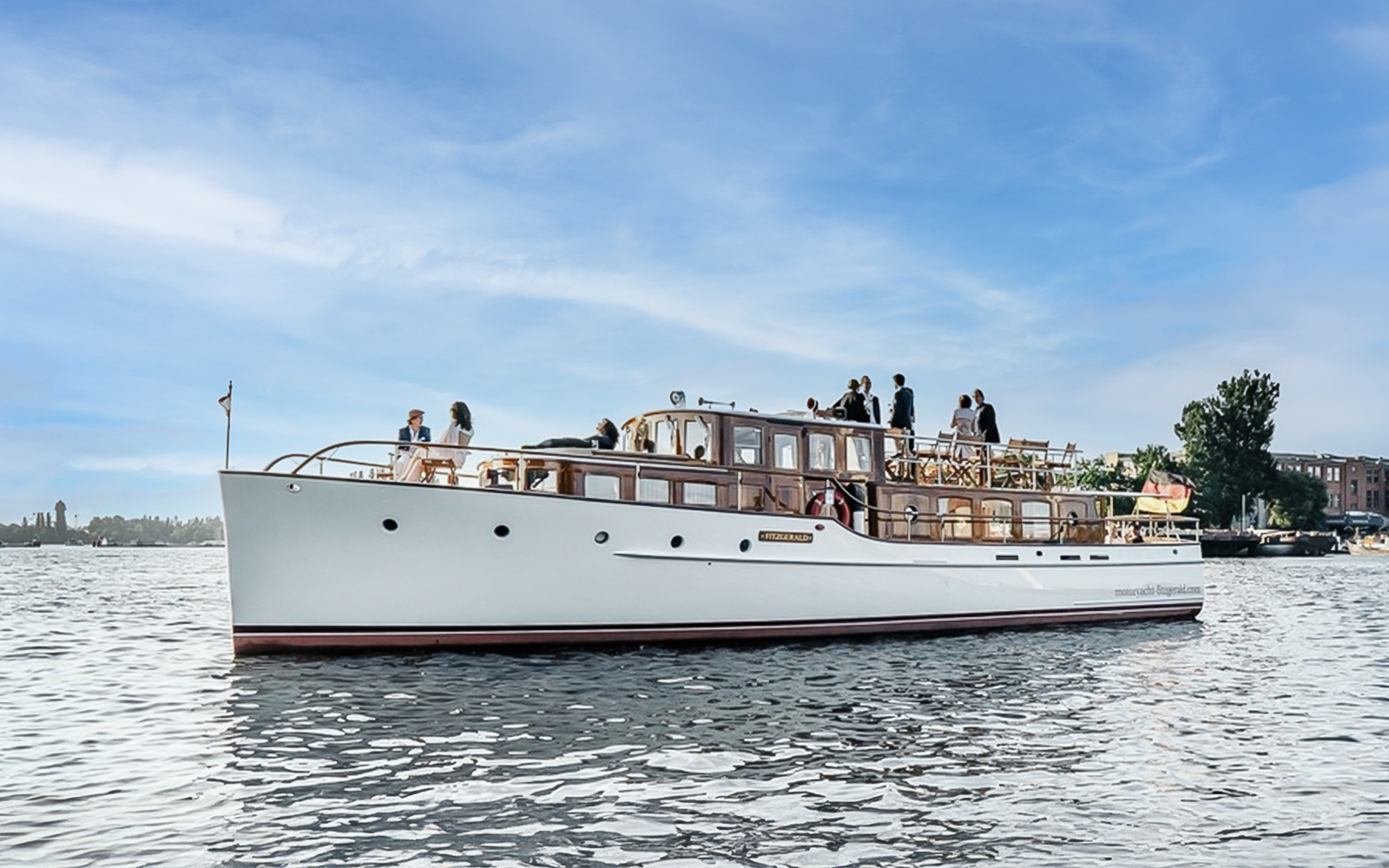 Fitzgerald boat cruising on Berlin river with passengers enjoying sightseeing.