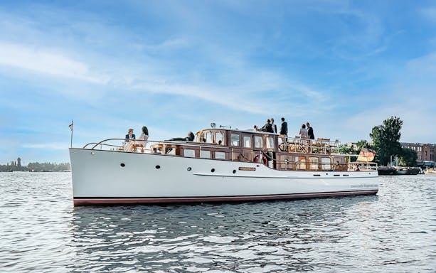 Fitzgerald boat cruising on Berlin river with passengers enjoying sightseeing.