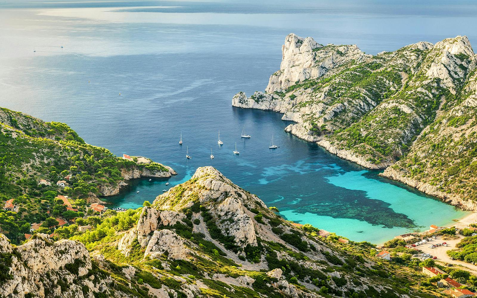 Sailboats in a turquoise cove at Calanques National Park, Marseille, Mediterranean Sea.