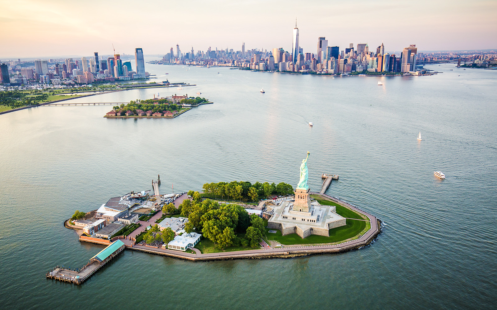 Statue of Liberty aerial view with Manhattan skyline in the background.
