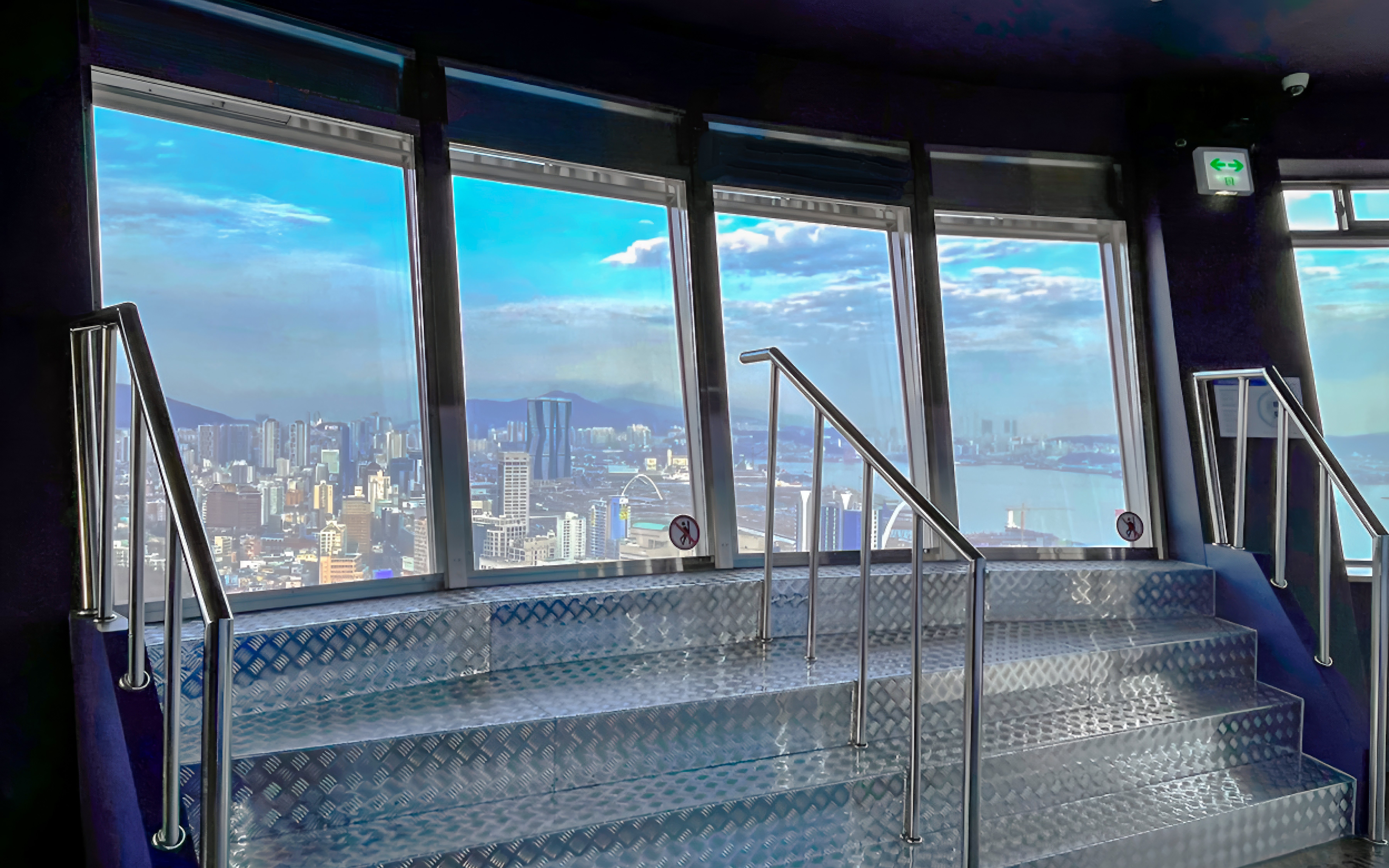 View from Busan Tower observatory overlooking cityscape and ocean.