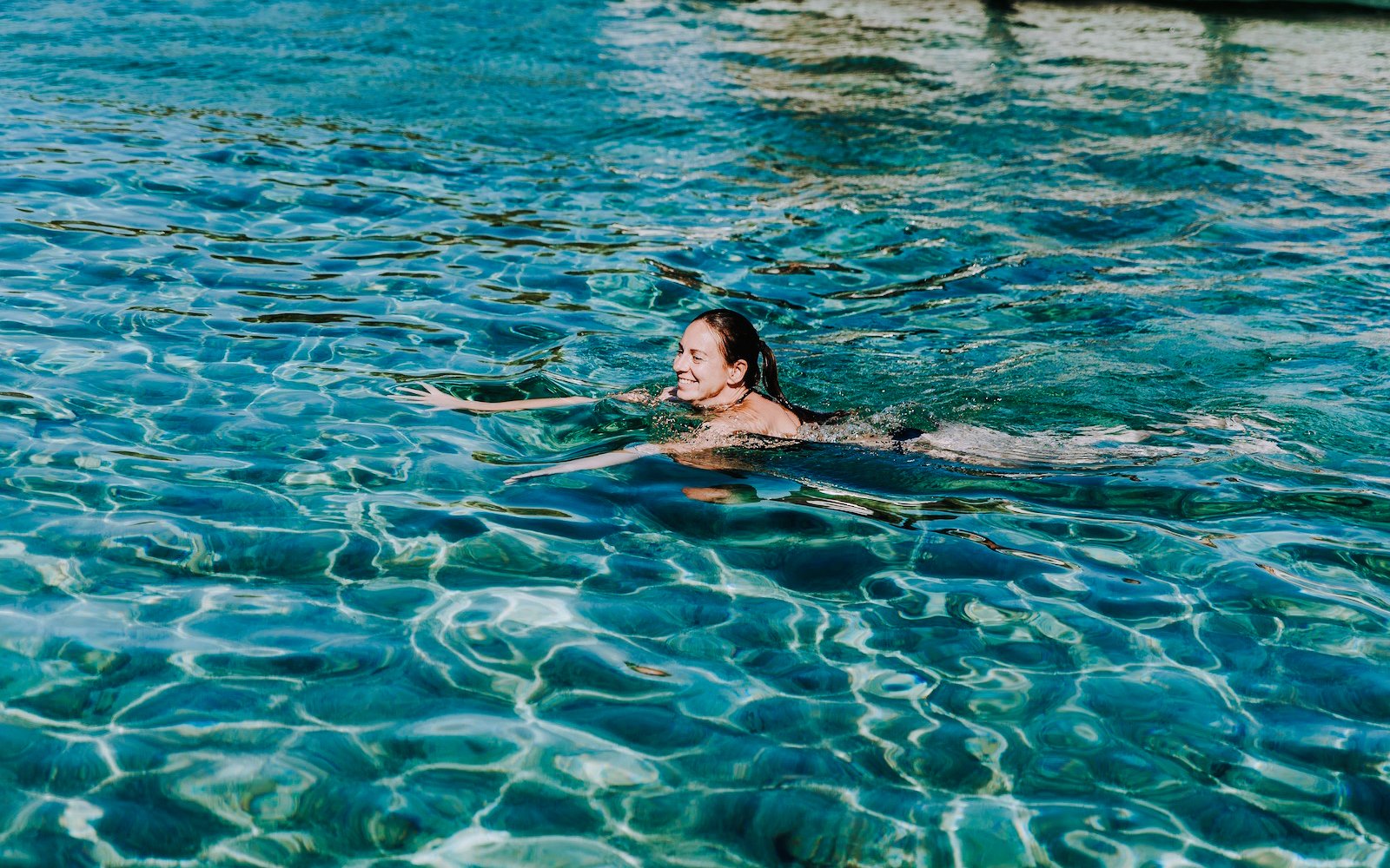 Guest swimming in clear waters during Blue Lagoon, Solta & Trogir Speedboat Tour.