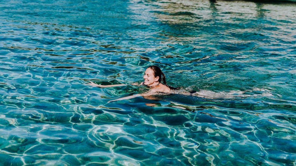 Guest swimming in clear waters during Blue Lagoon, Solta & Trogir Speedboat Tour.