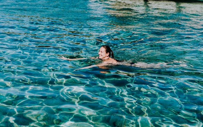 Guest swimming in clear waters during Blue Lagoon, Solta & Trogir Speedboat Tour.