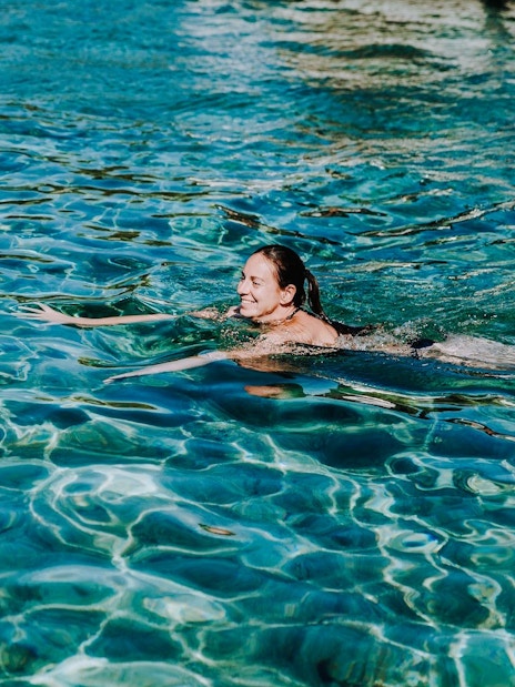 Guest swimming in clear waters during Blue Lagoon, Solta & Trogir Speedboat Tour.