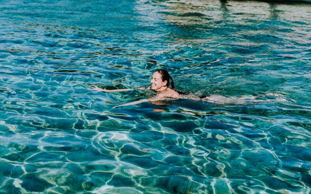 Guest swimming in clear waters during Blue Lagoon, Solta & Trogir Speedboat Tour.