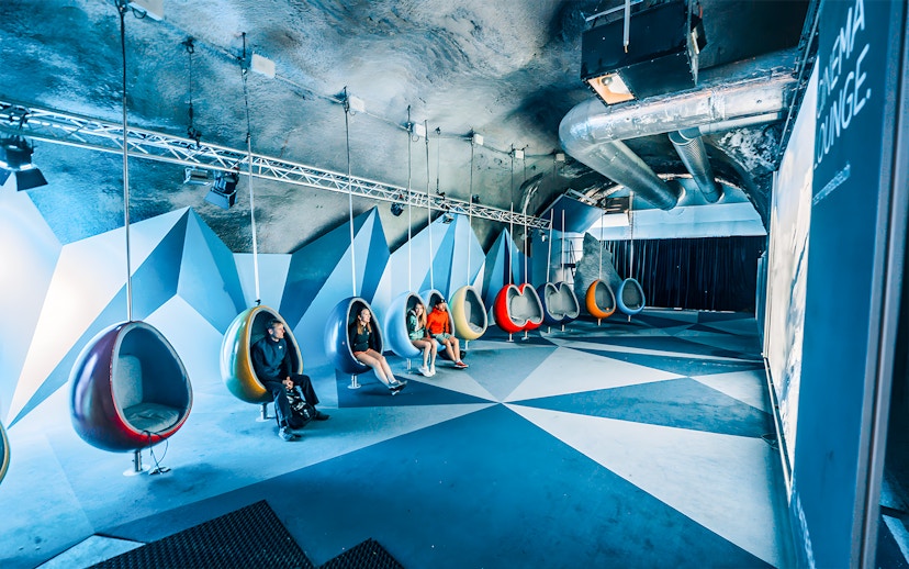 People seated in hanging chairs in the Cinema Room at Matterhorn Glacier Paradise.